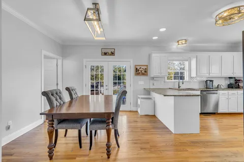 a view of a dining room with furniture and wooden floor