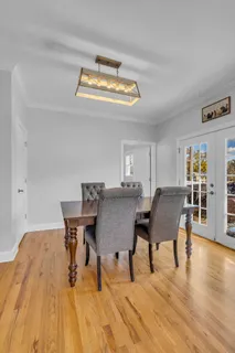 a kitchen with granite countertop a sink cabinets and wooden floor