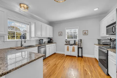 a kitchen with a sink cabinets and stainless steel appliances