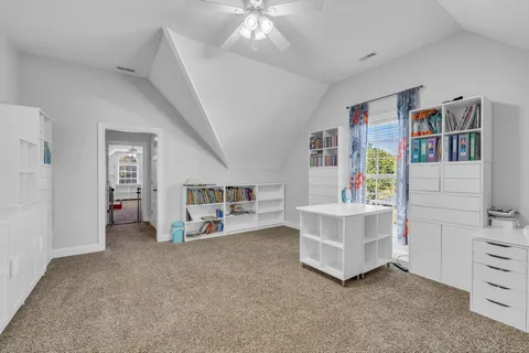 a view of an empty room with cabinet and stairs