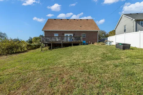 a view of a swimming pool with an outdoor seating and a yard
