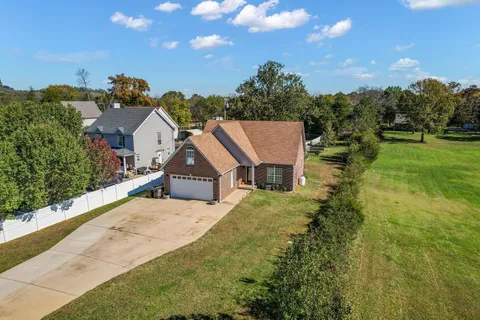 a view of house with yard