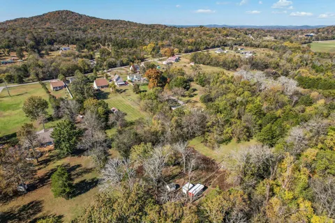 an aerial view of residential house with outdoor space and swimming pool
