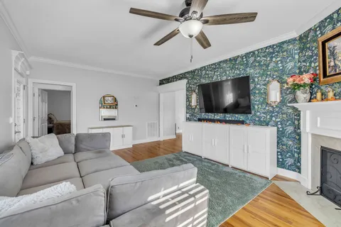 a living room with a fireplace and a flat screen tv