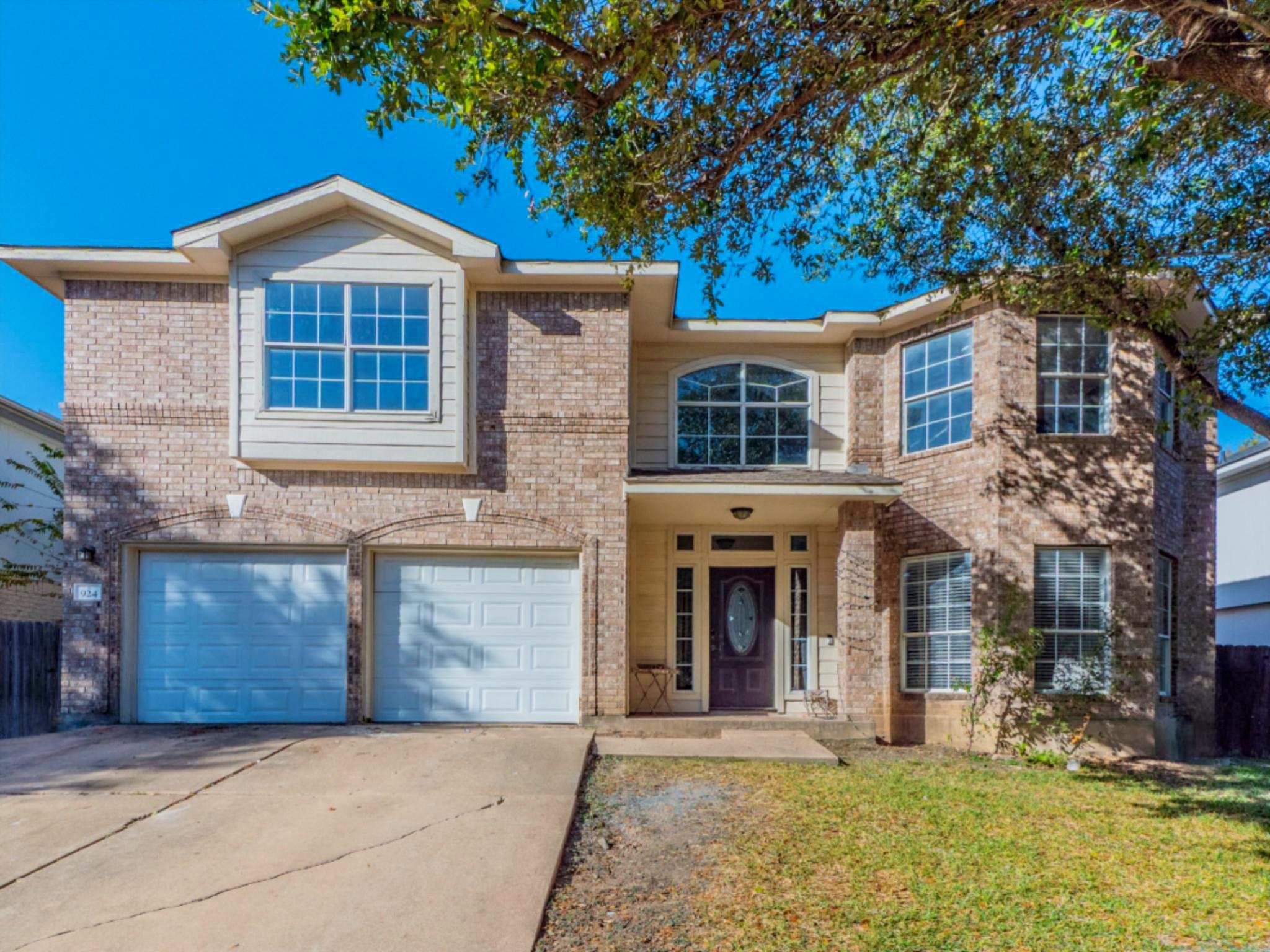 924 Satellite View Round Rock, TX 78665 - Photo 1 of 1 Traditional home with a garage, concrete driveway, a front lawn, and brick/siding