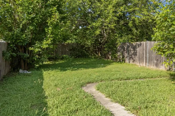 a view of a backyard with large trees