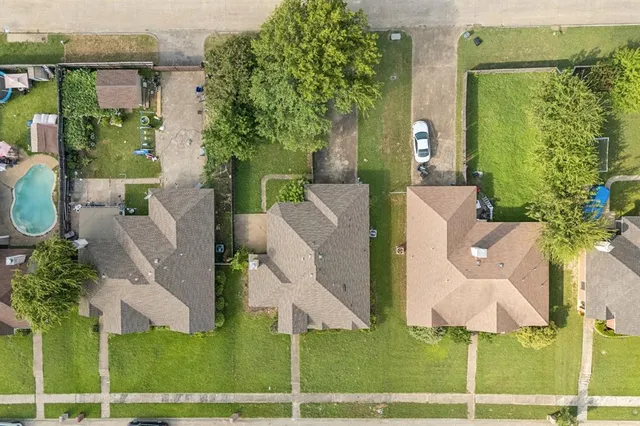 an aerial view of a house with outdoor space