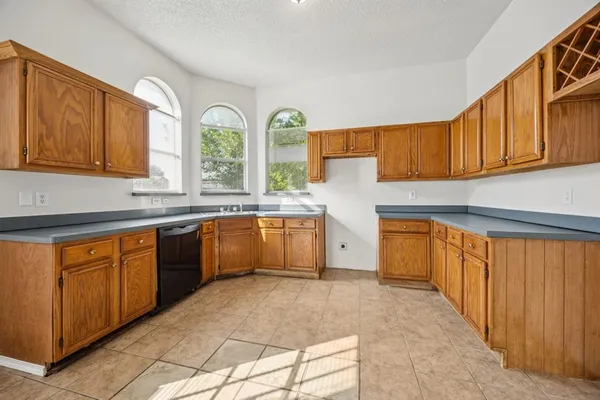a kitchen with stainless steel appliances granite countertop a stove sink and cabinets