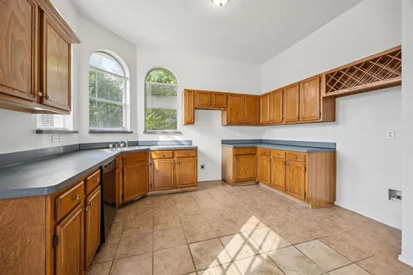 a kitchen with a sink and a stove top oven