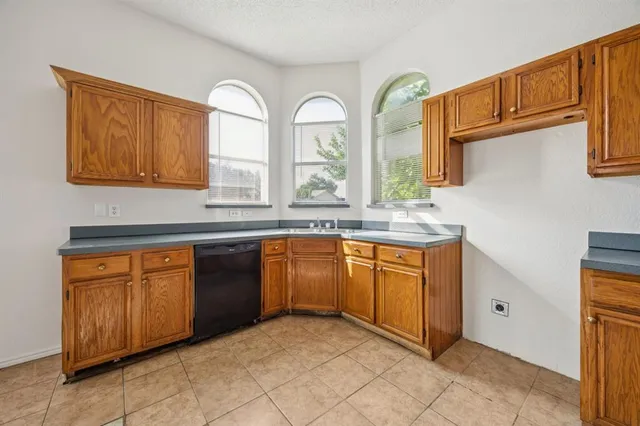 a kitchen with stainless steel appliances granite countertop a stove a sink and a granite counter tops