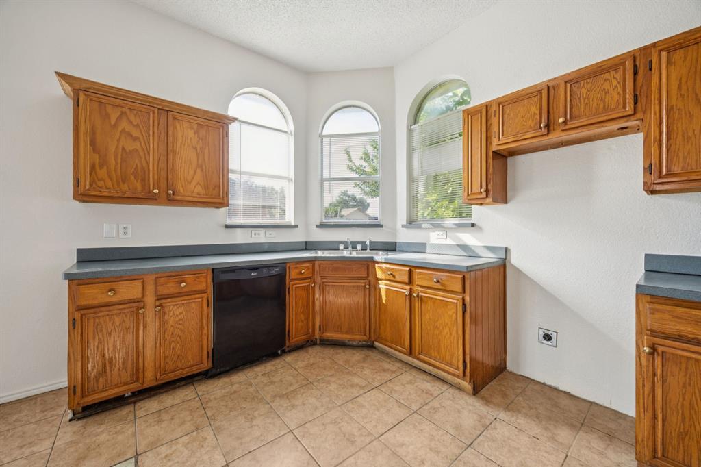 1602 Develon Drive Mesquite, TX 75149 - Photo 9 of 22 a kitchen with stainless steel appliances granite countertop a stove a sink and a granite counter tops