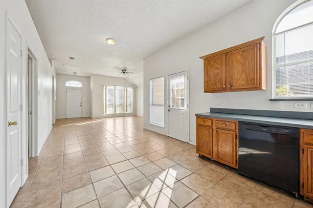 a view of a kitchen with granite countertop cabinets