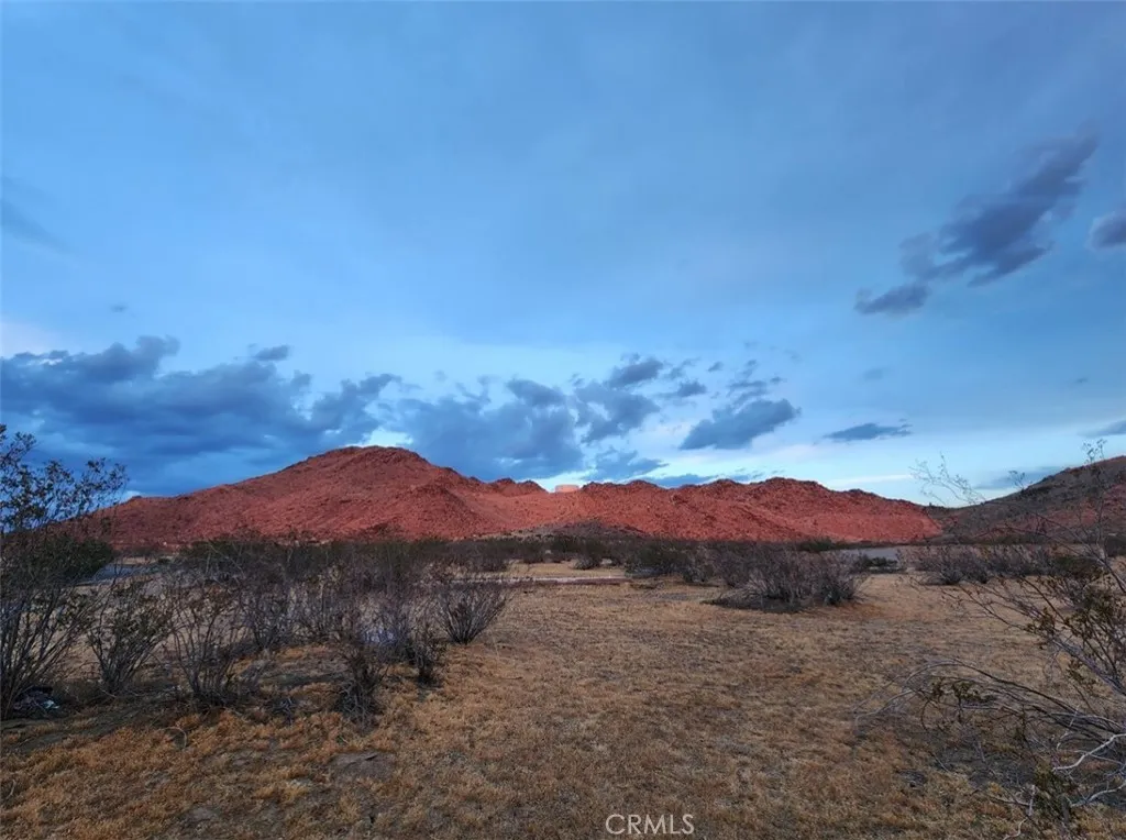 0 Roanoke Road Apple Valley, CA 92307 - Photo 13 of 15 a view of a lush green hillside and a building