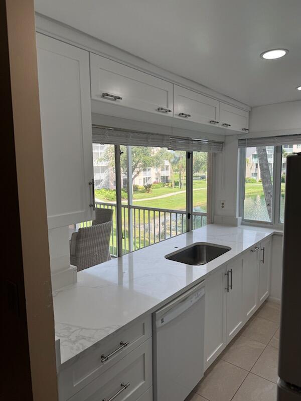 353 Highway 1, Unit A203 Jupiter, FL 33477 - Photo 12 of 26 a kitchen with a sink and large window