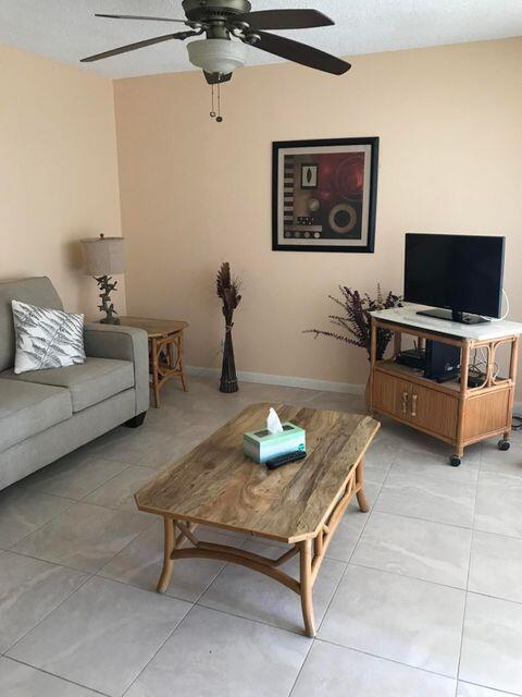353 Highway 1, Unit A203 Jupiter, FL 33477 - Photo 7 of 26 a living room with furniture and a flat screen tv