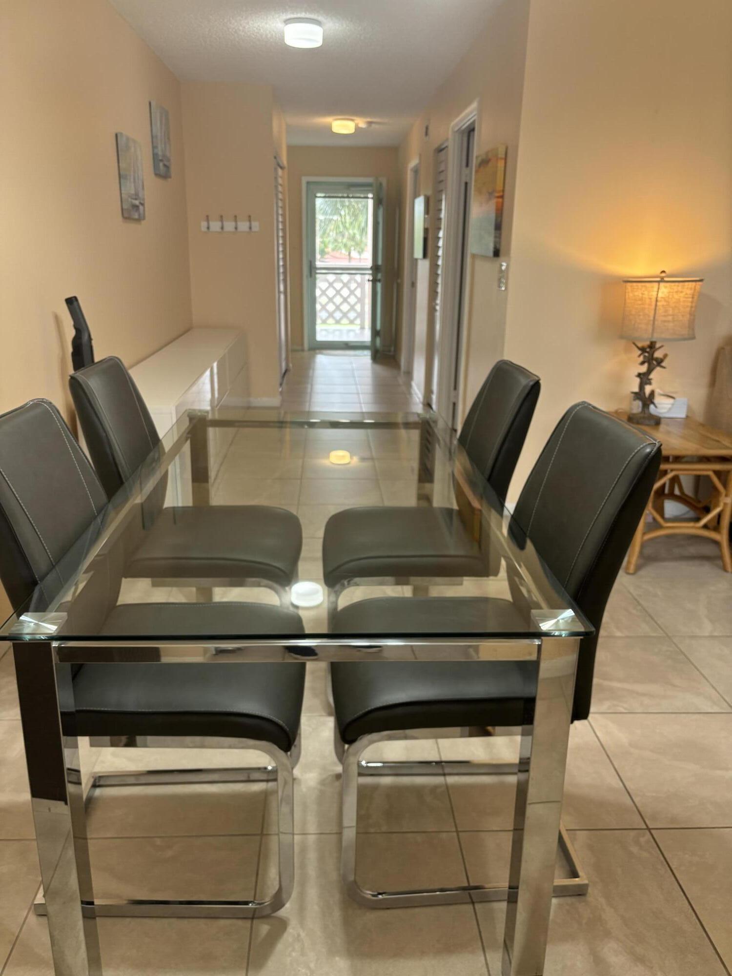 353 Highway 1, Unit A203 Jupiter, FL 33477 - Photo 9 of 26 a view of kitchen with stainless steel appliances wooden floor and chair