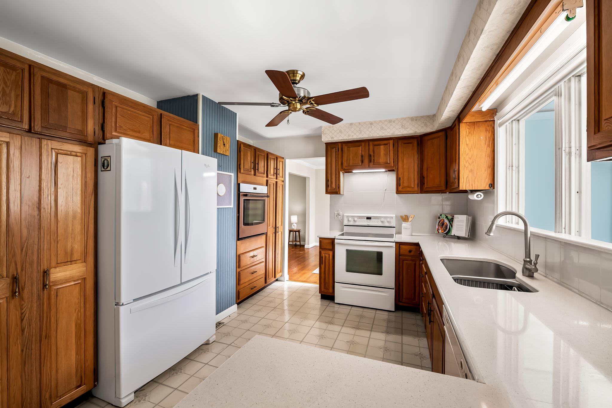 2619 Bradenbaugh Road White Hall, MD 21161 - Photo 14 of 50 a kitchen with granite countertop a refrigerator a sink a stove and cabinets