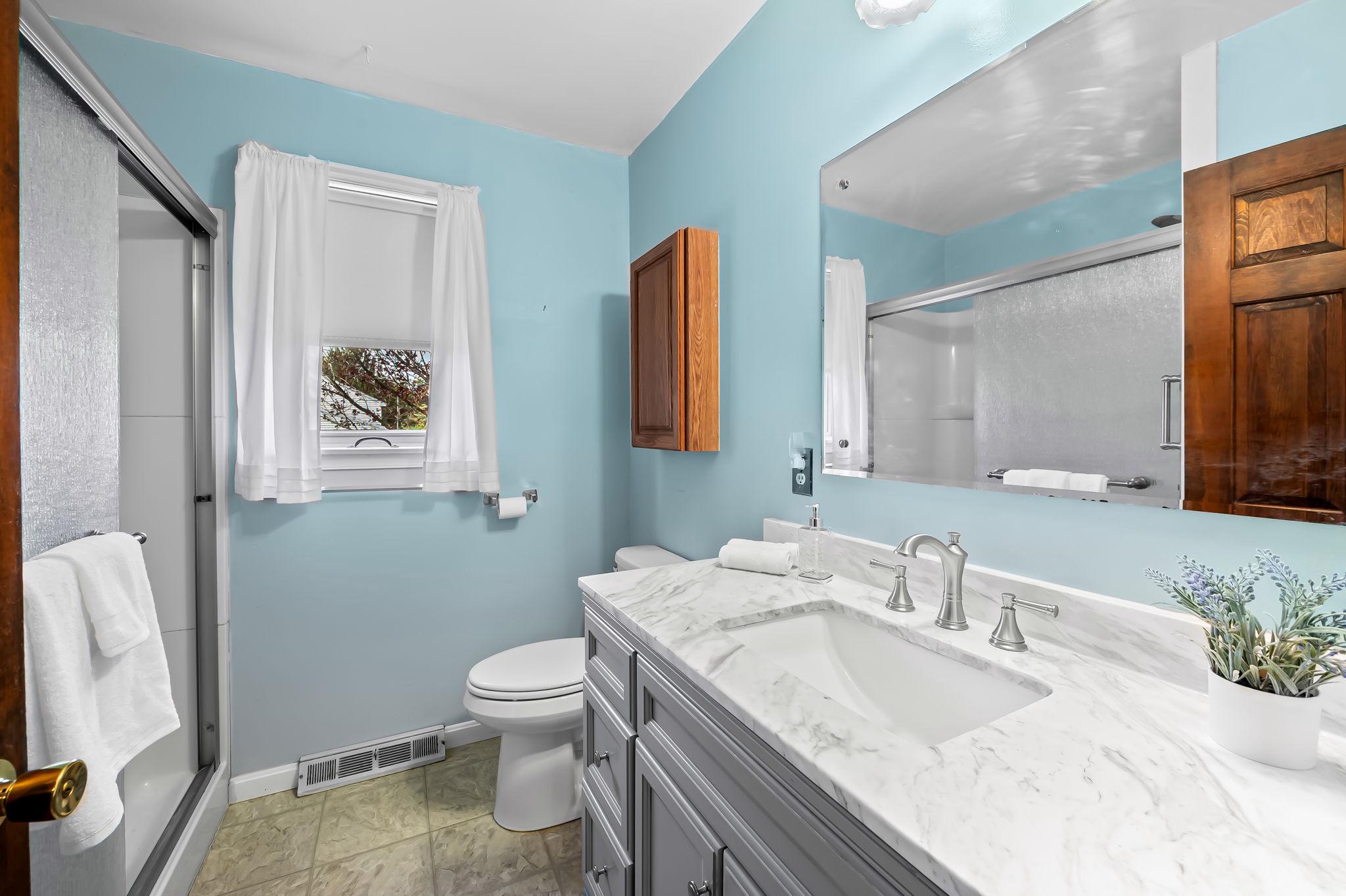 2619 Bradenbaugh Road White Hall, MD 21161 - Photo 24 of 50 a bathroom with a granite countertop toilet sink and mirror