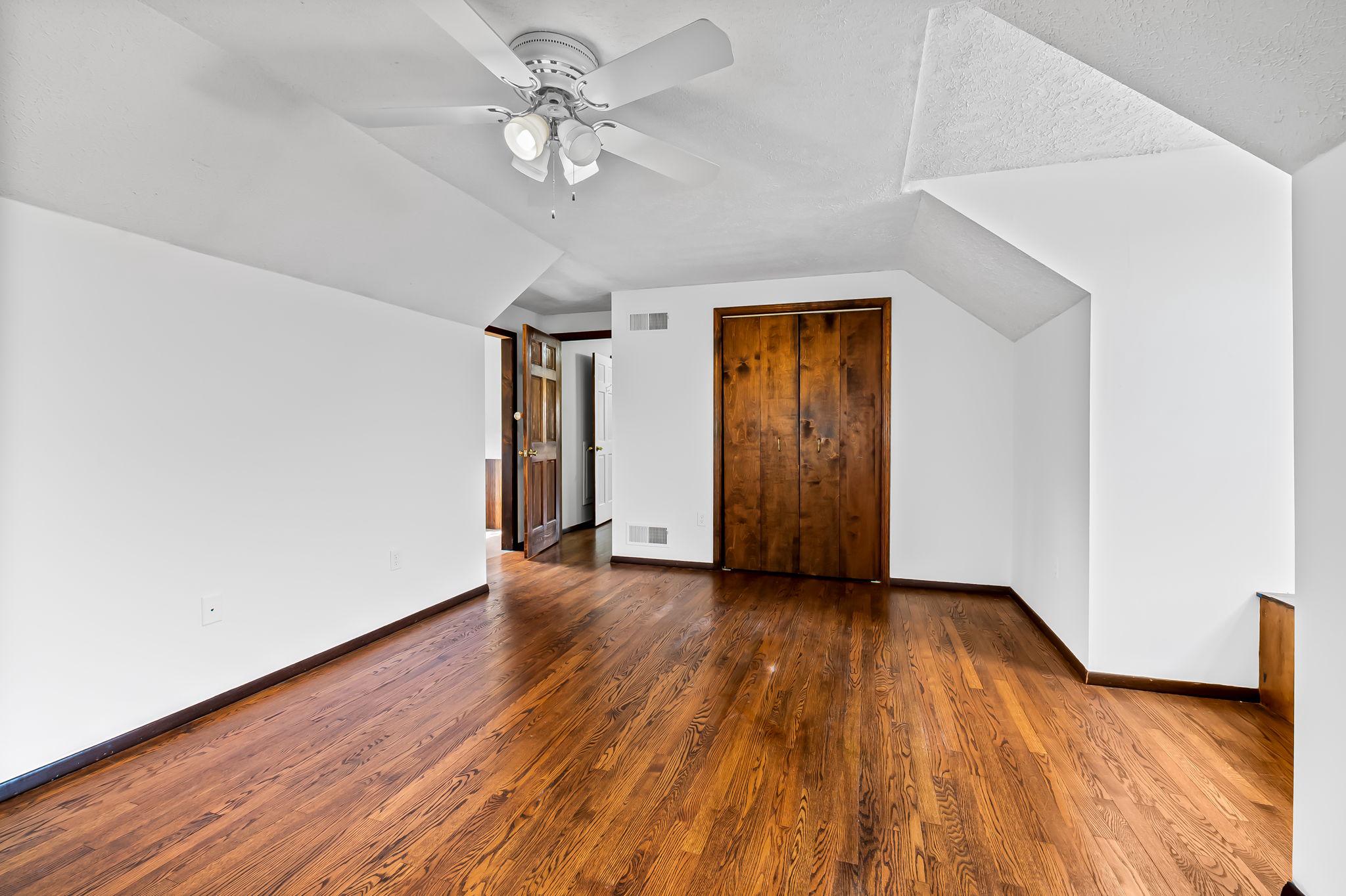 2619 Bradenbaugh Road White Hall, MD 21161 - Photo 32 of 50 an empty room with wooden floor and ceiling fan