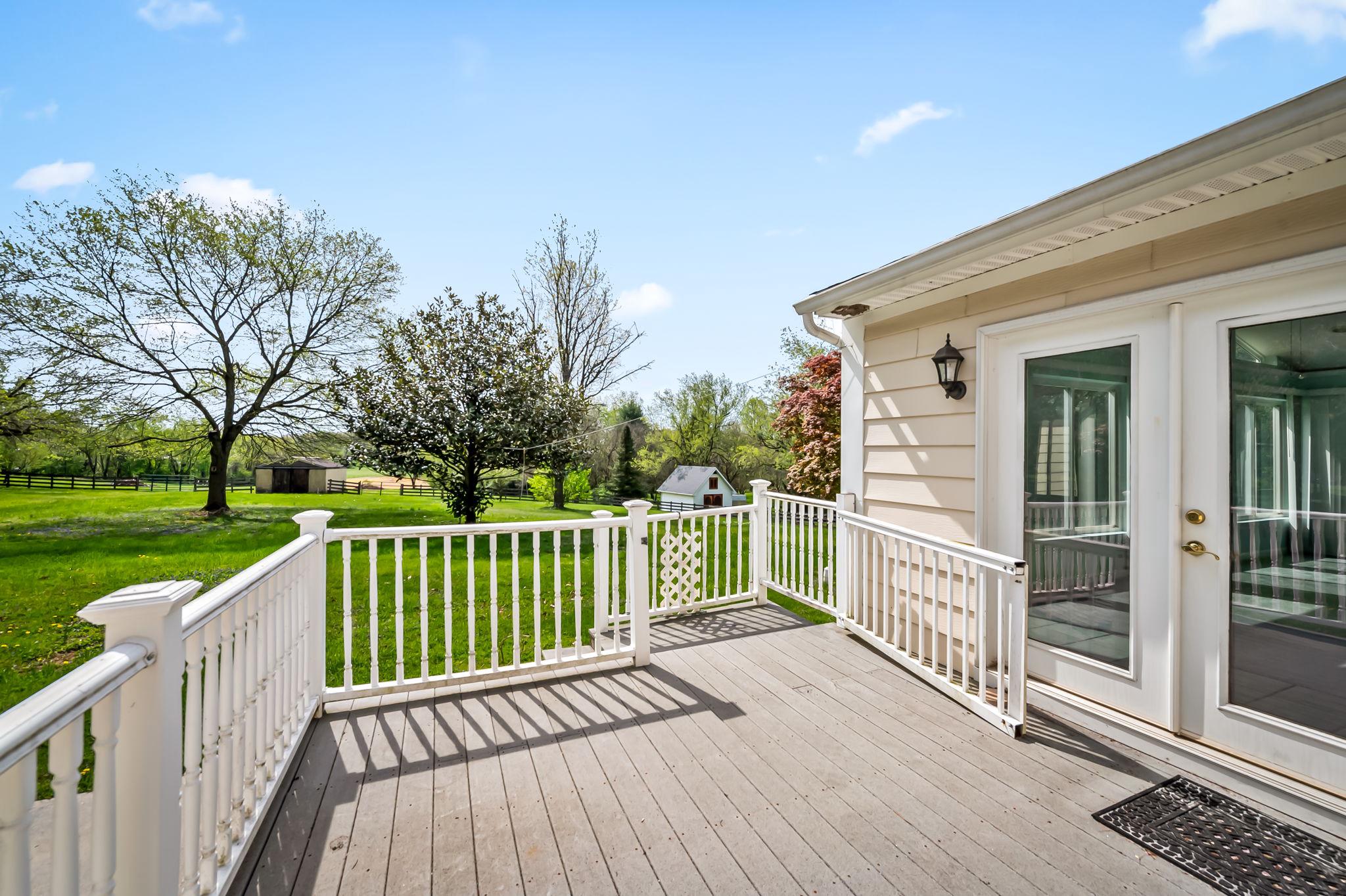 2619 Bradenbaugh Road White Hall, MD 21161 - Photo 38 of 50 a view of a wooden deck with a big yard and large trees
