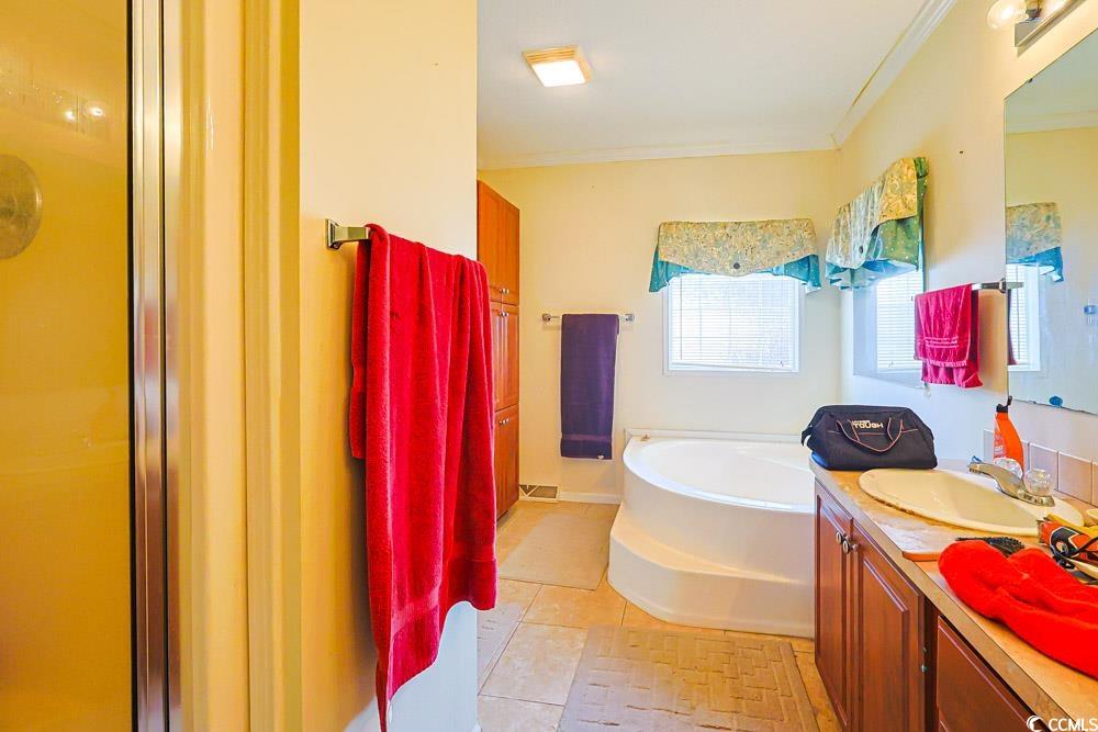 1291 Highway 701 Highway Loris, SC 29569 - Photo 16 of 40 Full bath with vanity, a garden tub, a shower stall, and ornamental molding
