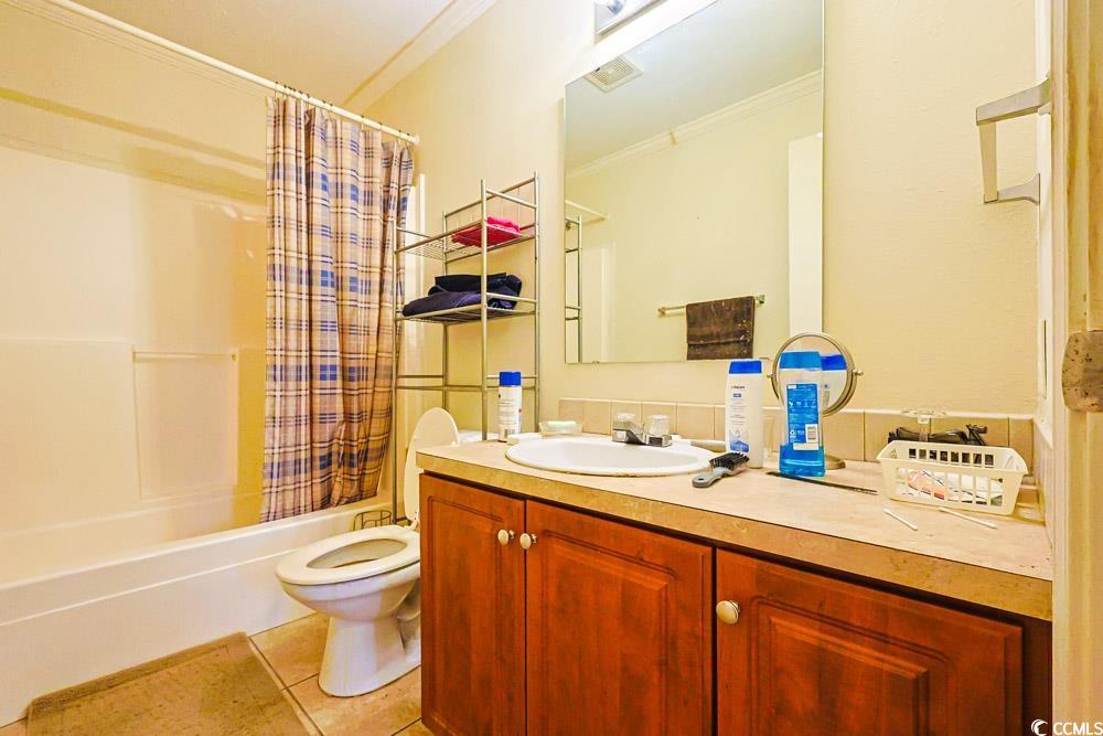 1291 Highway 701 Highway Loris, SC 29569 - Photo 26 of 40 Full bath with ornamental molding, vanity, light tile patterned flooring, and shower / bath combination with curtain