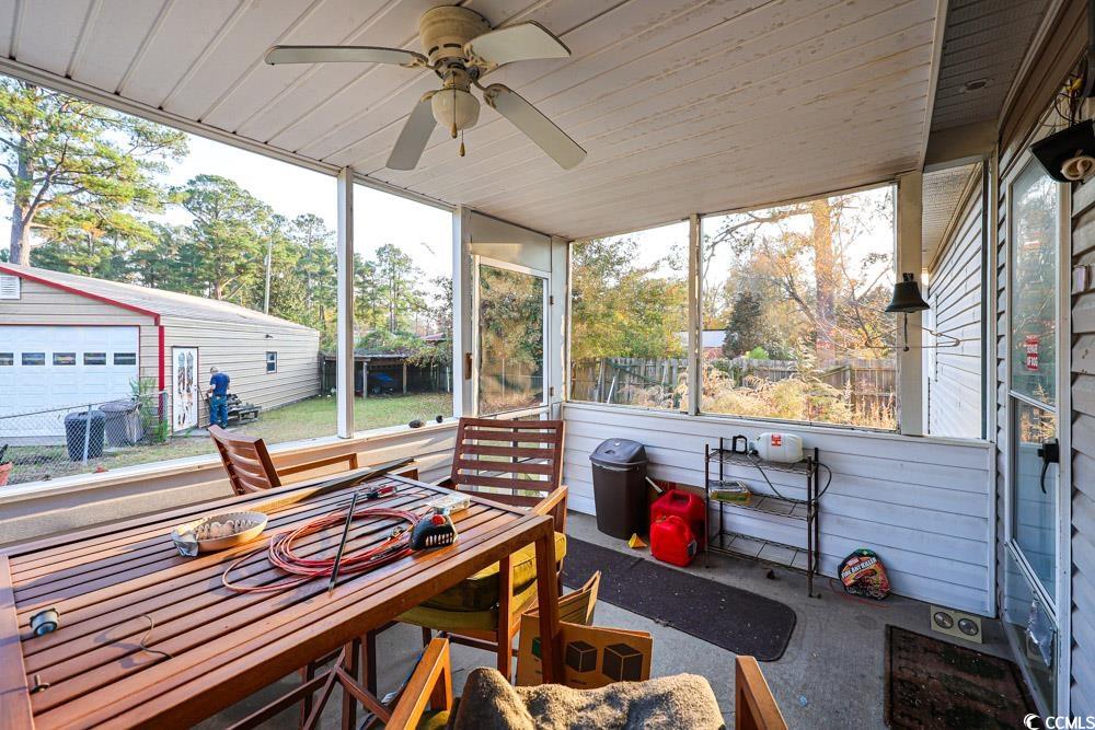 1291 Highway 701 Highway Loris, SC 29569 - Photo 29 of 40 Sunroom featuring outdoor dining area and a ceiling fan