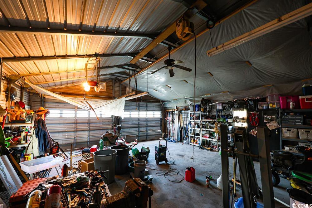 1291 Highway 701 Highway Loris, SC 29569 - Photo 34 of 40 Garage with metal wall, a ceiling fan, and a workshop area