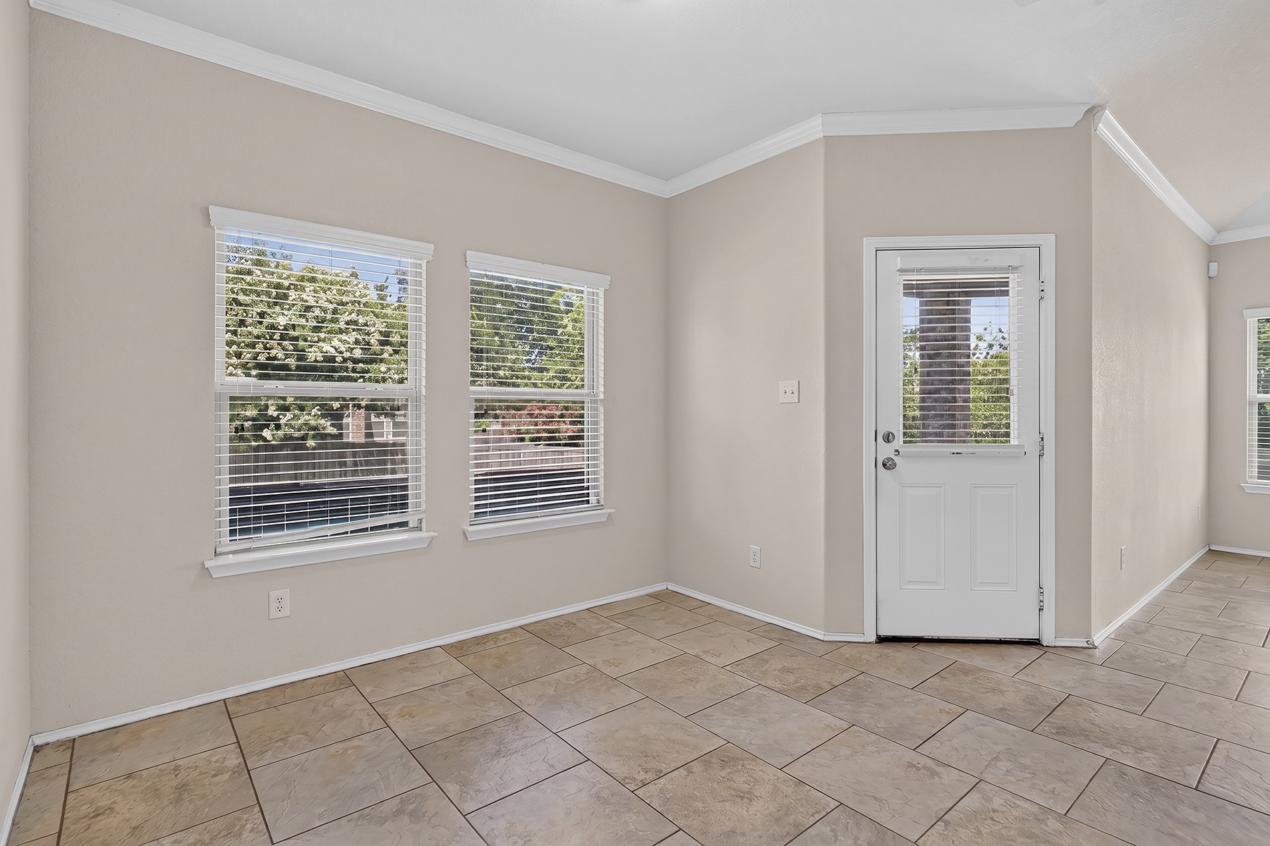 4601 Chestnut Meadows Bend Georgetown, TX 78626 - Photo 10 of 35 Natural light filters through multiple windows, illuminating the spacious tiled flooring and inviting entryway.