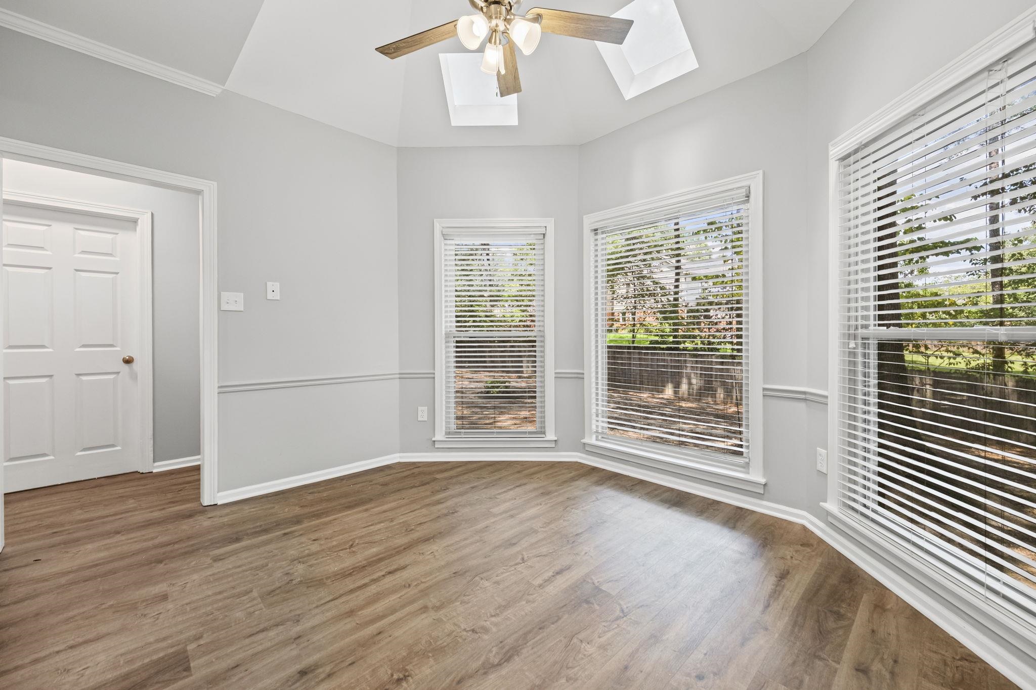 9190 East Bridge Drive Germantown, TN 38139 - Photo 16 of 37 Unfurnished room with a skylight, wood finished floors, and ceiling fan