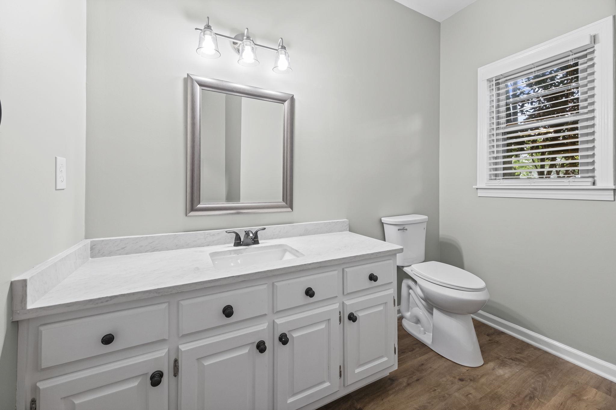9190 East Bridge Drive Germantown, TN 38139 - Photo 18 of 37 Half bathroom featuring vanity and dark wood-type flooring