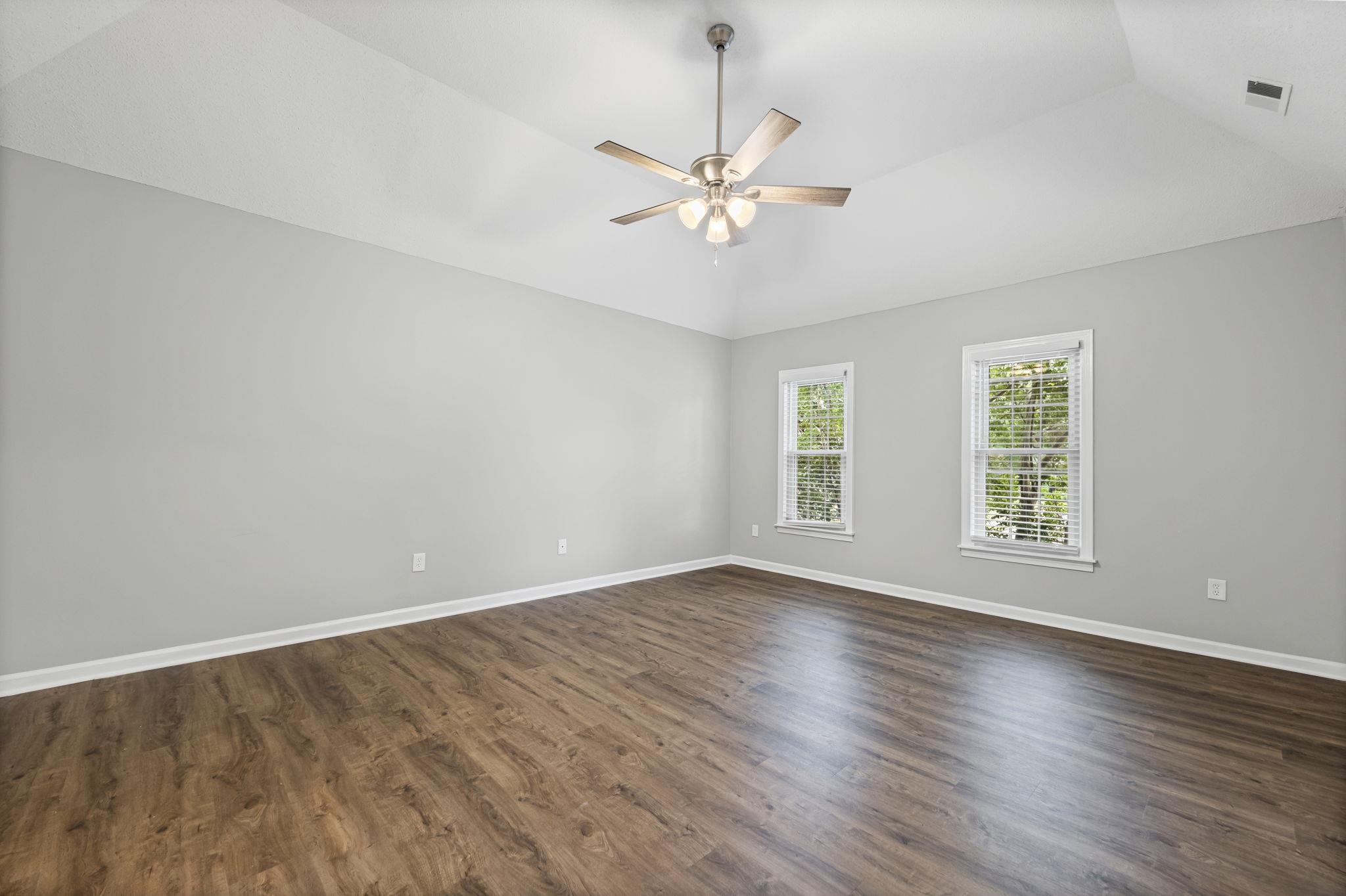 9190 East Bridge Drive Germantown, TN 38139 - Photo 19 of 37 Spare room featuring dark wood finished floors, lofted ceiling, and a ceiling fan