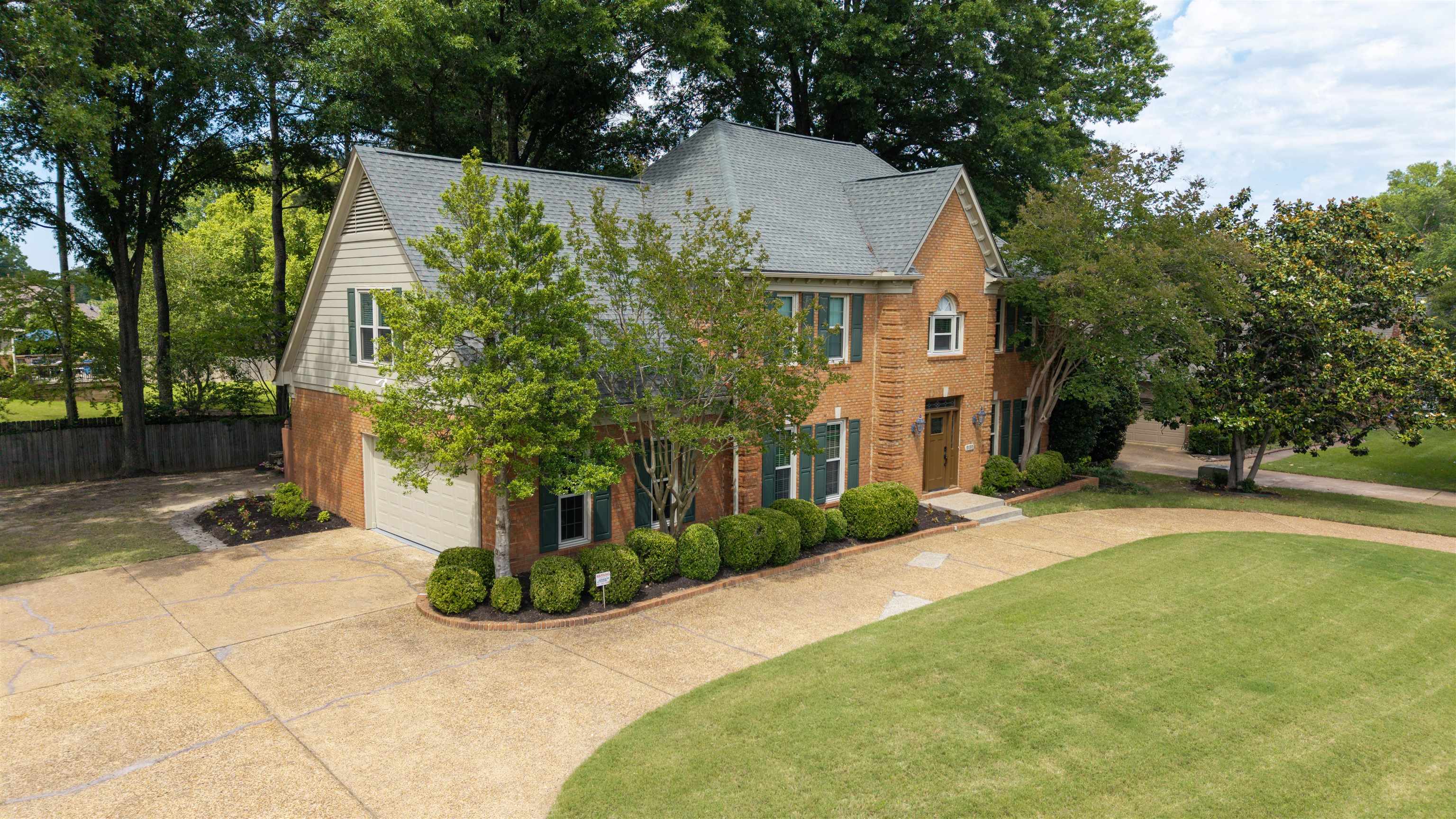 9190 East Bridge Drive Germantown, TN 38139 - Photo 2 of 37 Traditional brick exterior featuring a multi-gabled roof and an attached garage