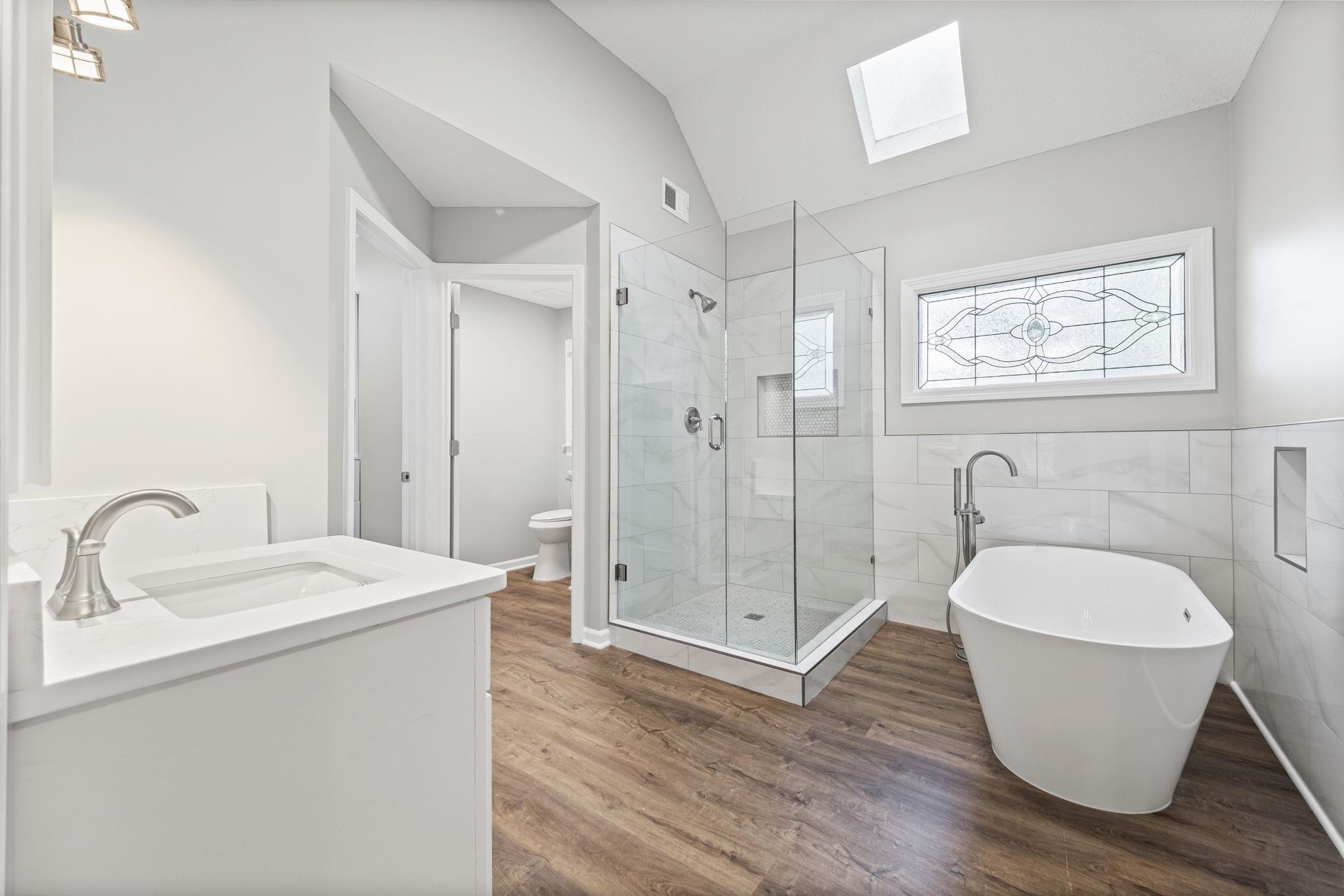 9190 East Bridge Drive Germantown, TN 38139 - Photo 21 of 37 Full bath featuring a skylight, vanity, a soaking tub, a stall shower, and vaulted ceiling