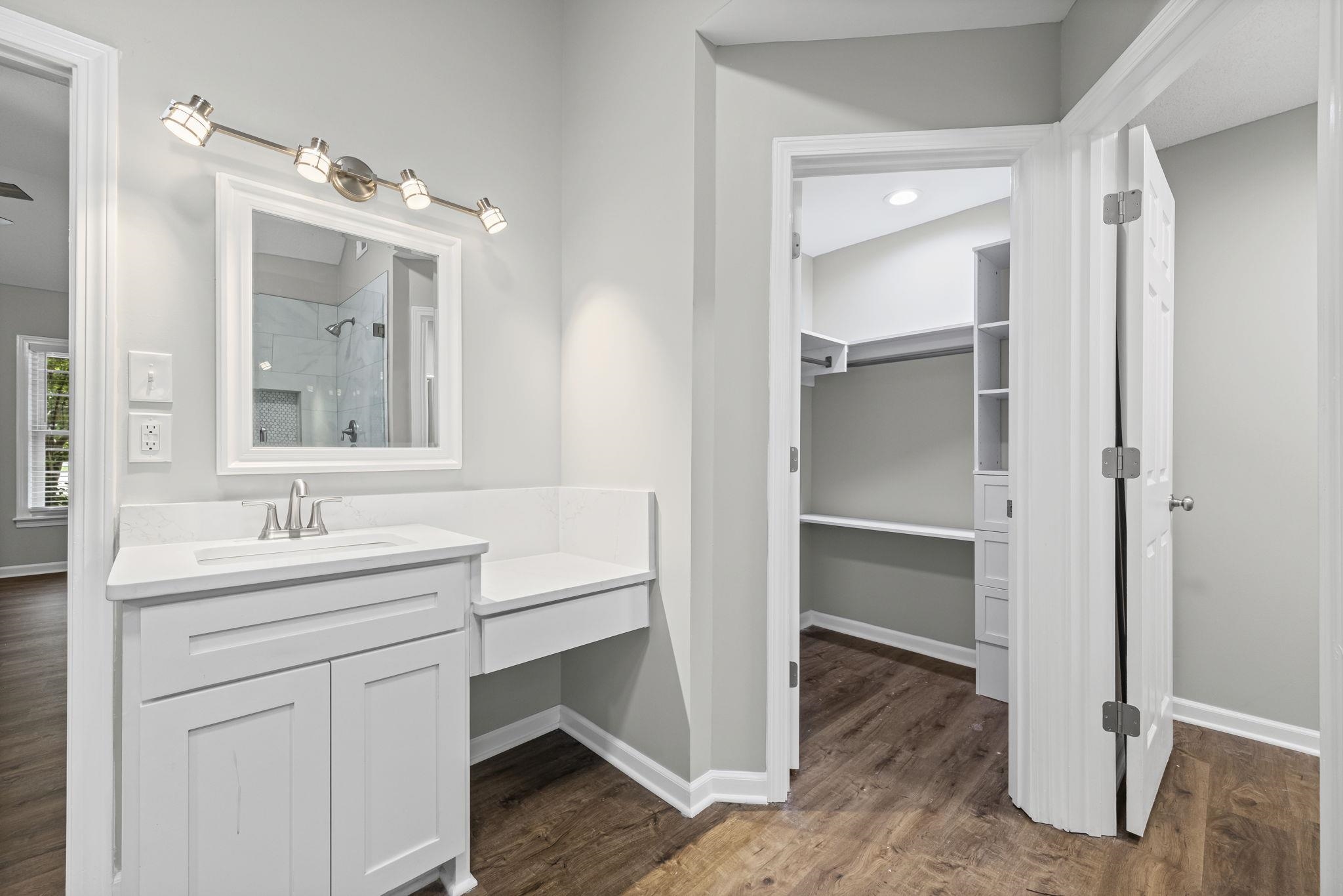9190 East Bridge Drive Germantown, TN 38139 - Photo 23 of 37 Bathroom with a stall shower, dark wood-style floors, vanity, and a walk in closet