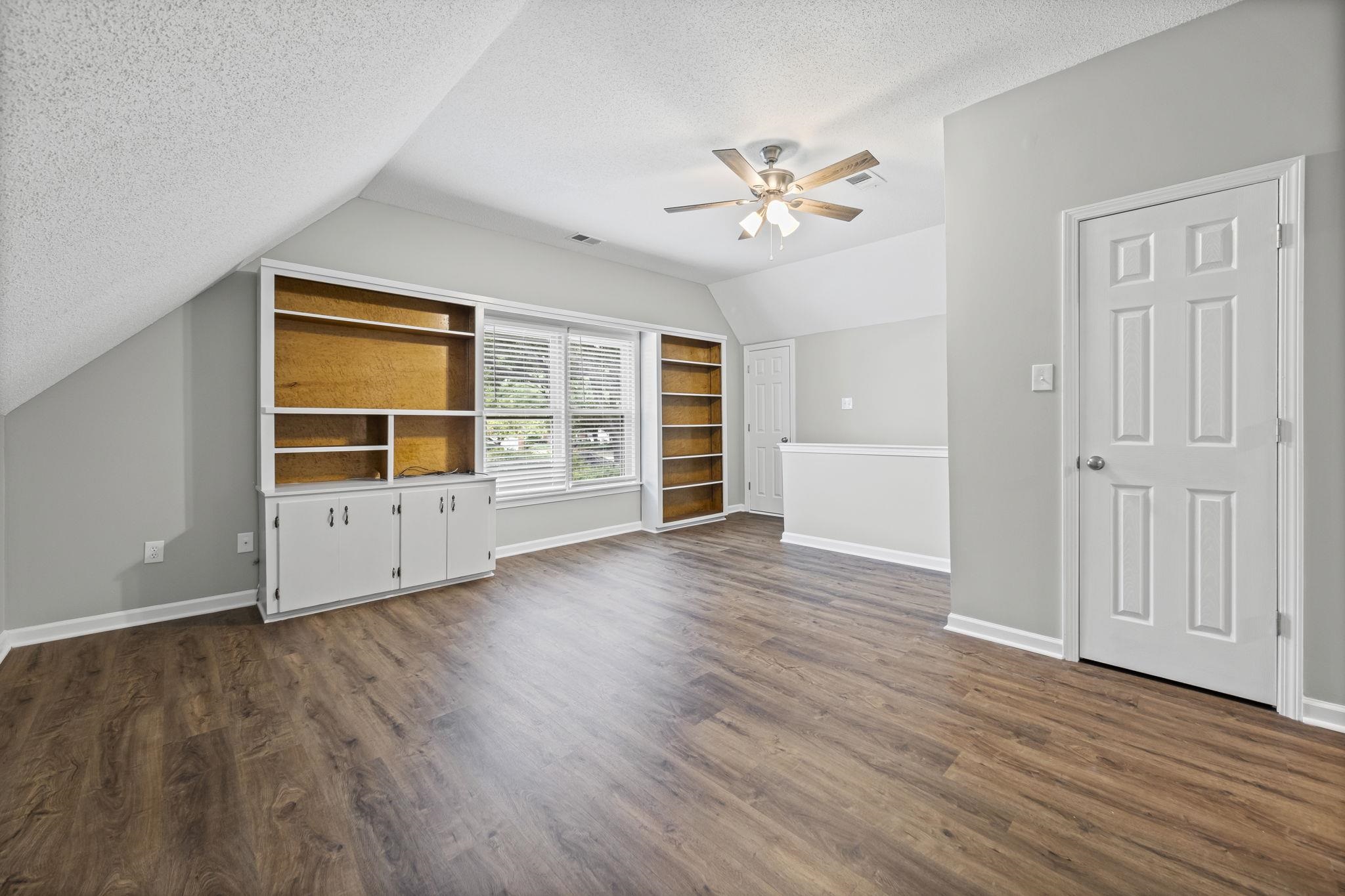 9190 East Bridge Drive Germantown, TN 38139 - Photo 29 of 37 Unfurnished living room with a textured ceiling, dark wood-type flooring, ceiling fan, and lofted ceiling