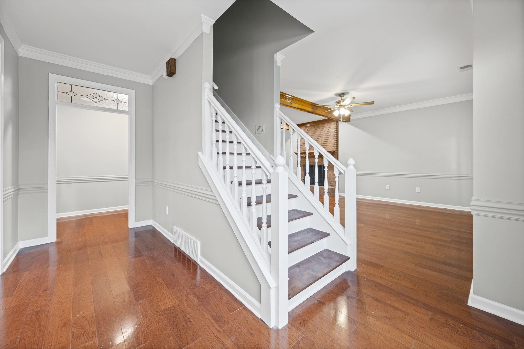9190 East Bridge Drive Germantown, TN 38139 - Photo 4 of 37 Stairway with crown molding, wood finished floors, and a ceiling fan