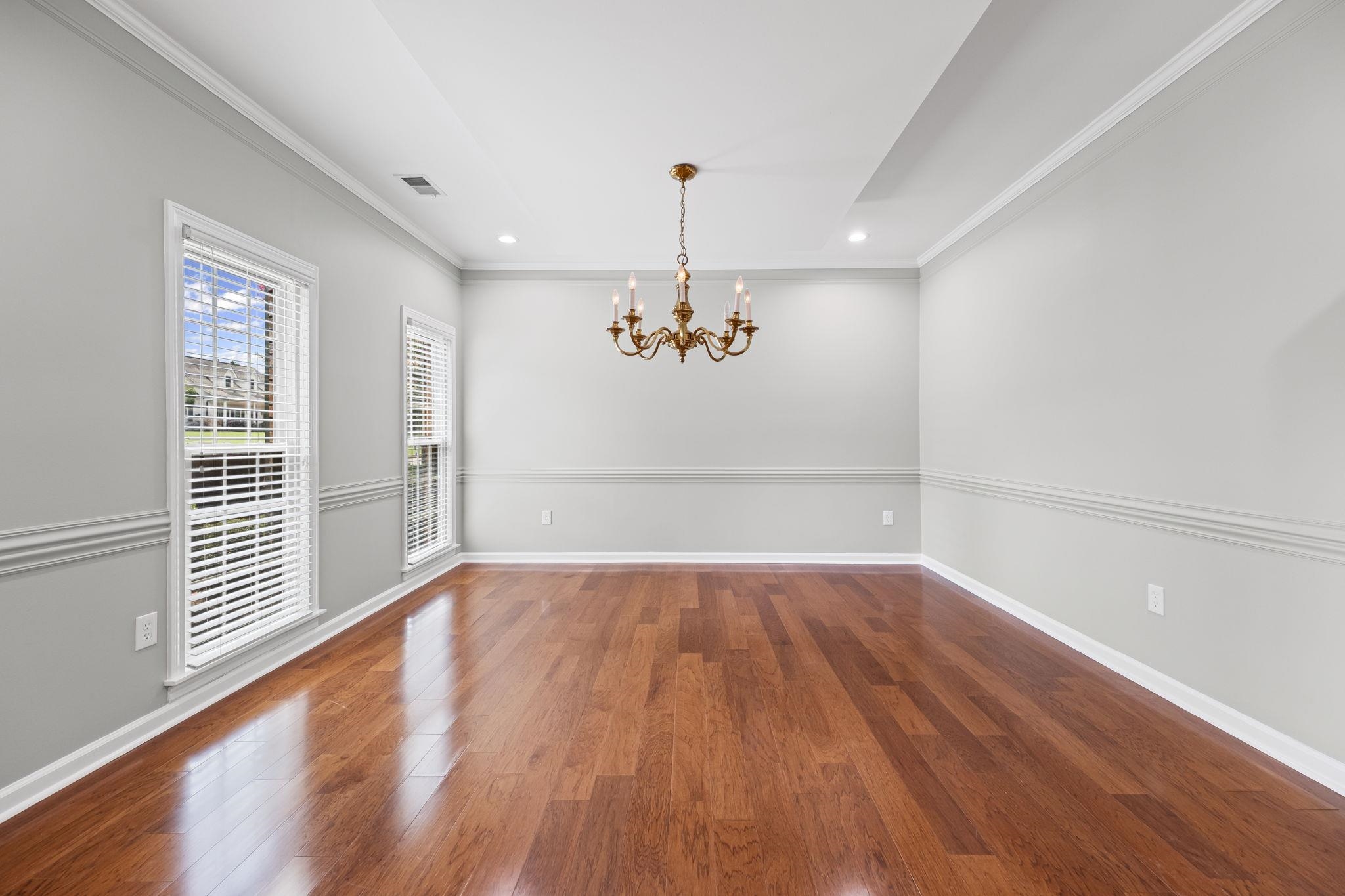 9190 East Bridge Drive Germantown, TN 38139 - Photo 8 of 37 Unfurnished dining area featuring ornamental molding, dark wood-style flooring, a chandelier, and recessed lighting