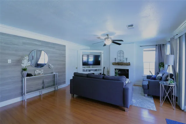 a living room with furniture a flat screen tv and a fireplace