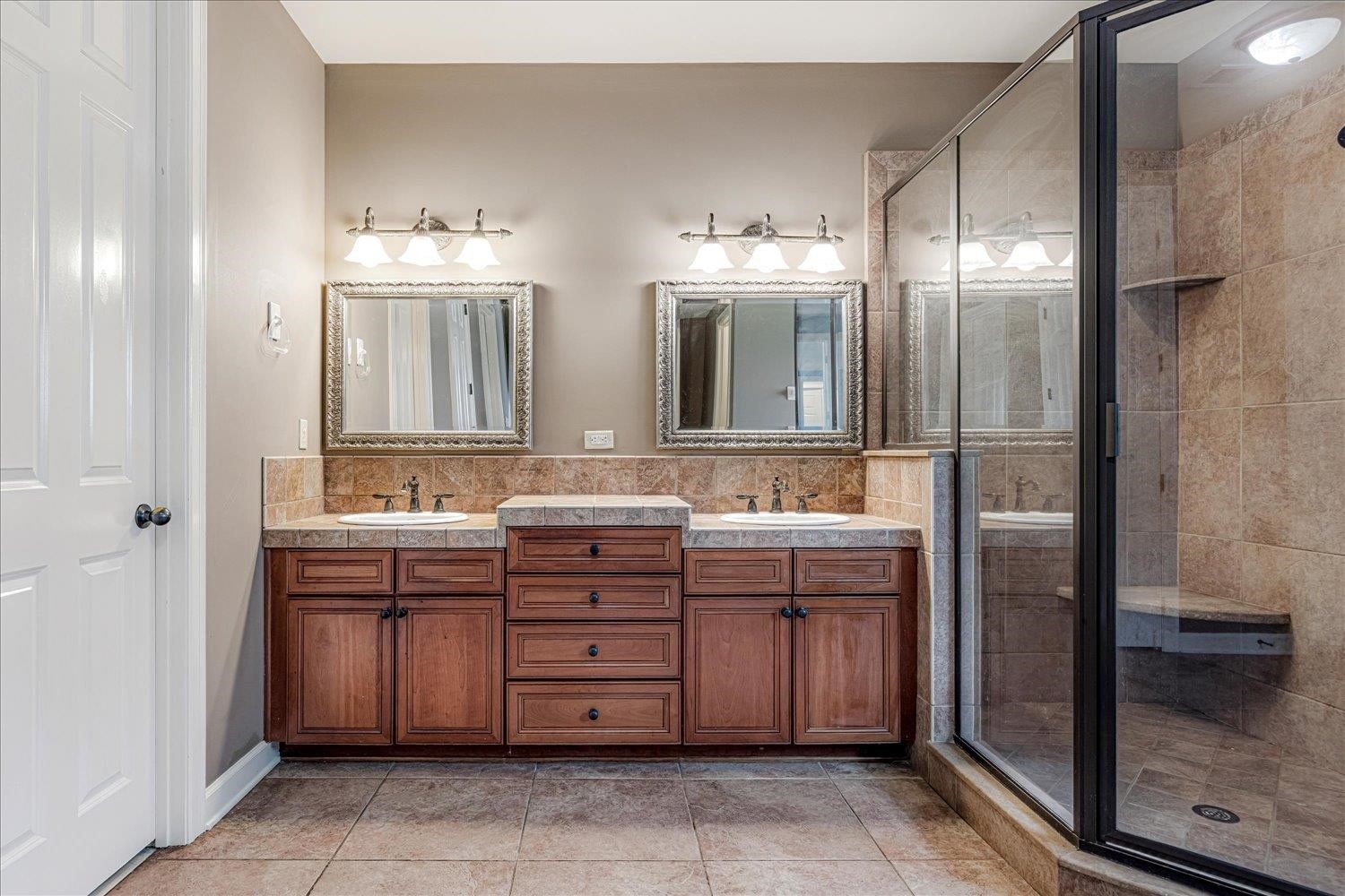 4597 Whisper Spring Drive Collierville, TN 38017 - Photo 18 of 39 a bathroom with a double vanity sink a mirror and a shower