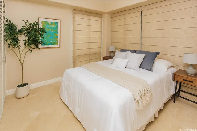 a bedroom with a bed and a potted plant