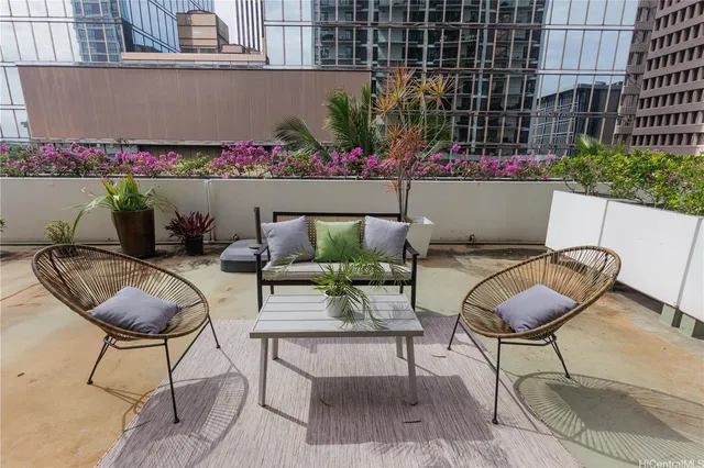 a view of a chairs and table in a backyard