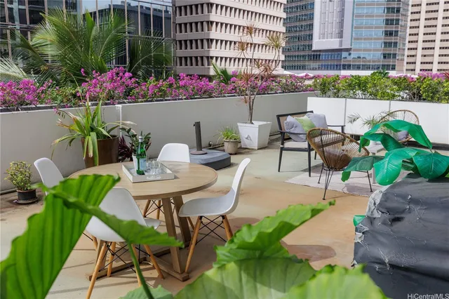 a view of a patio with table and chairs potted plants