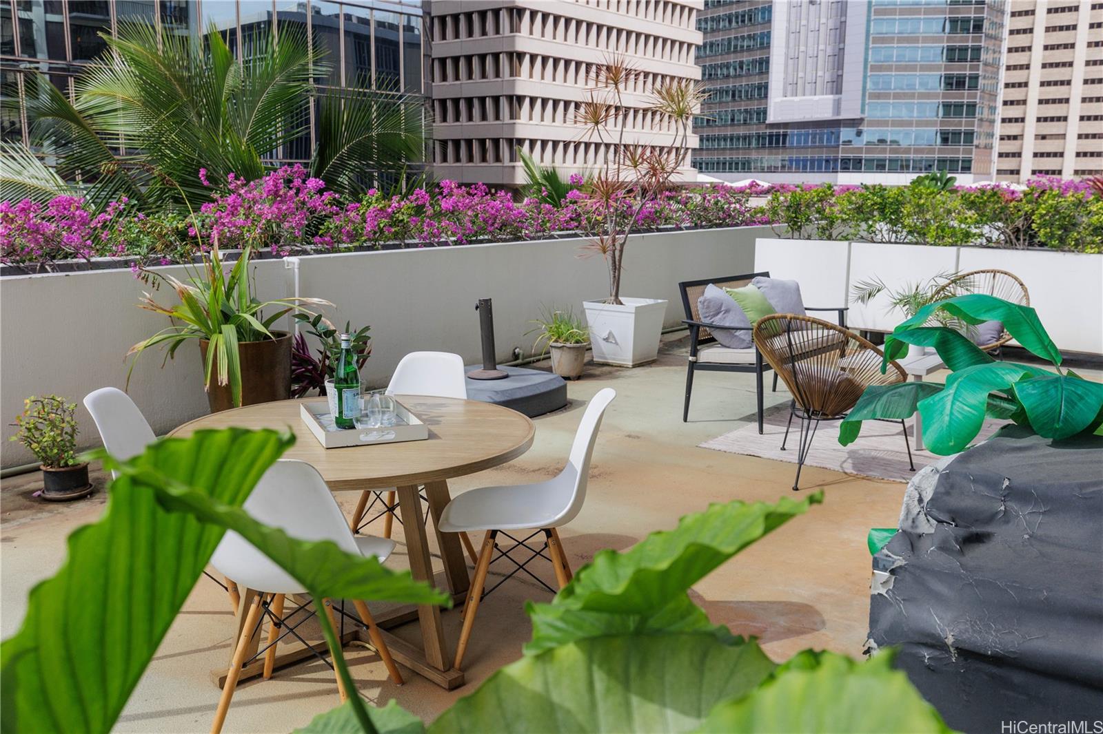 225 Queen Street, Unit 7A Honolulu, HI 96813 - Photo 15 of 18 a view of a chairs and table in a backyard