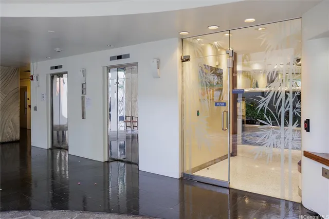 a front view of a house with a tree