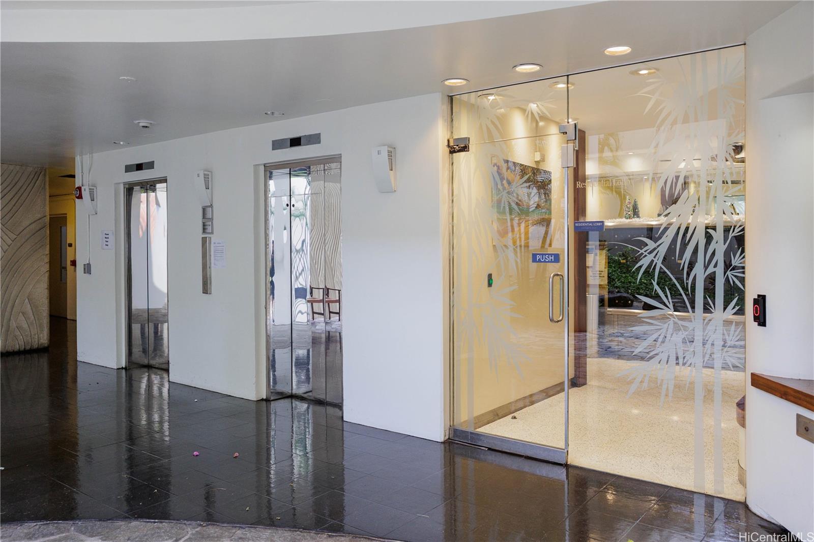 225 Queen Street, Unit 7A Honolulu, HI 96813 - Photo 17 of 18 a bathroom with a glass shower door