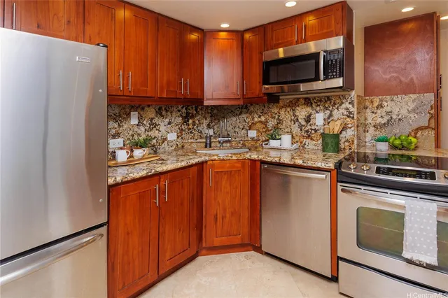 a kitchen with stainless steel appliances granite countertop wooden cabinets a stove top oven a sink and dishwasher
