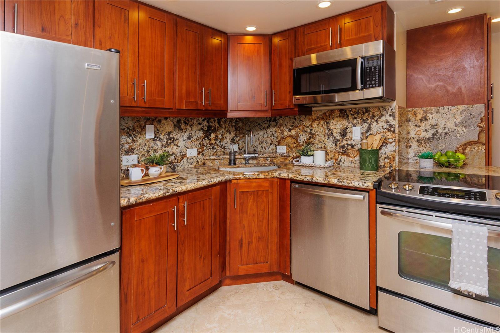 225 Queen Street, Unit 7A Honolulu, HI 96813 - Photo 5 of 18 a kitchen with stainless steel appliances granite countertop wooden cabinets a stove top oven a sink and dishwasher