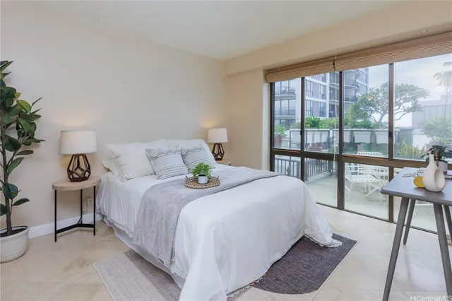 a bedroom with a bed and a large window