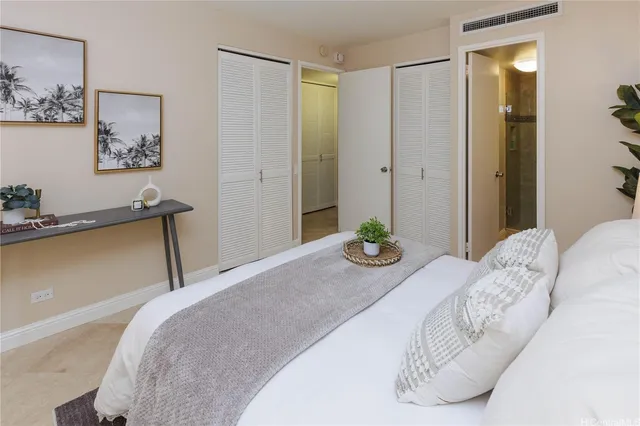 a bedroom with a bed and a painting on the wall